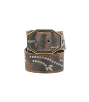 The Bed Stu Mohawk women’s belt features distressed leather, light leaf patterns, a weathered finish, and a large antique-style rectangular buckle for vintage-inspired charm.
