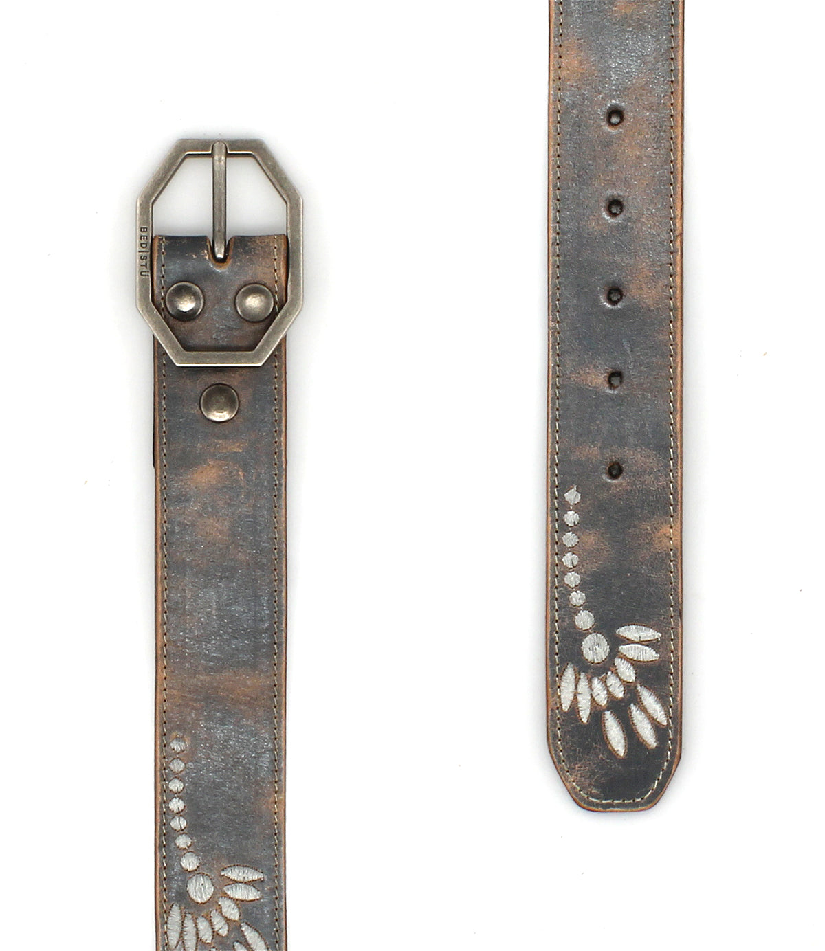 The Mohawk women's floral belt by Bed Stu features distressed leather, a silver buckle, metal rivets, and a white leaf pattern at the tip, adding vintage charm to any outfit.