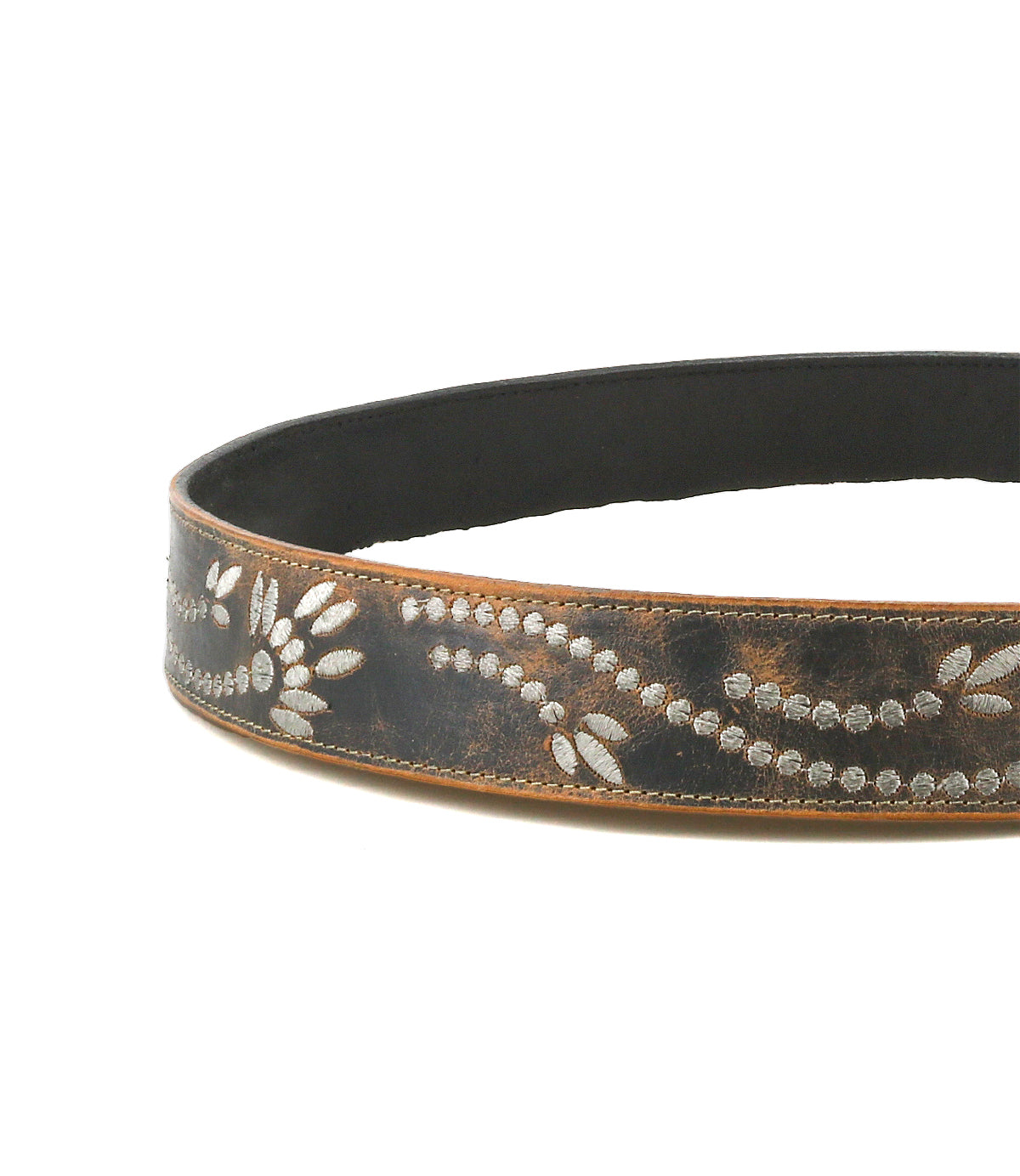 The Bed Stu Mohawk is a women's brown distressed leather belt adorned with light floral and dotted patterns etched along its length.
