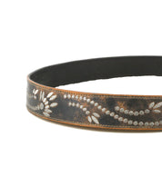 The Bed Stu Mohawk is a women's brown distressed leather belt adorned with light floral and dotted patterns etched along its length.