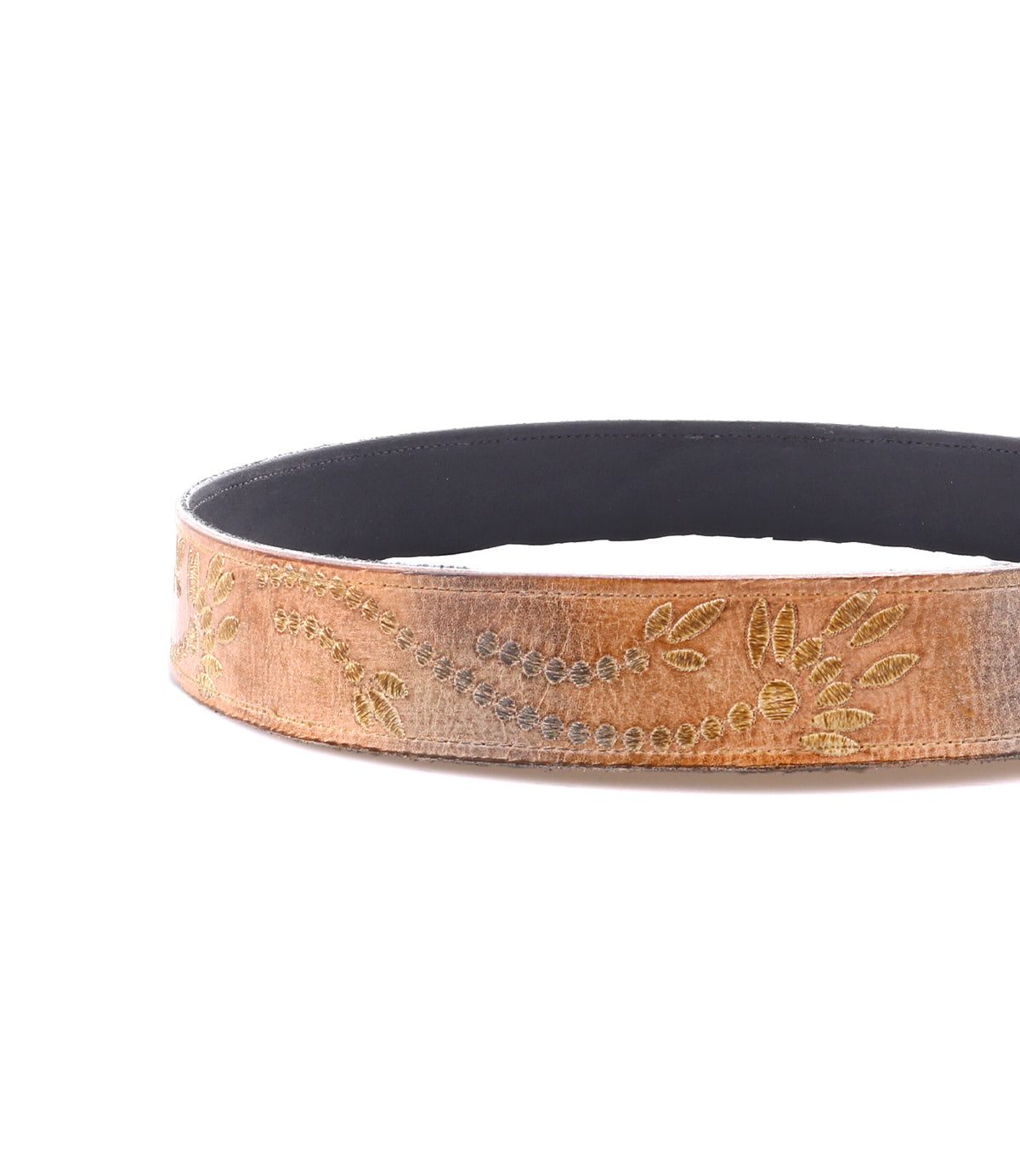 The Bed Stu Mohawk belt, made of brown distressed leather with embroidered floral and vine patterns, is displayed coiled with its inner side facing up.