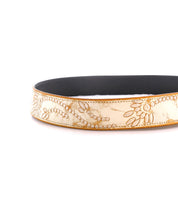 A close-up of the Mohawk headband by Bed Stu, featuring decorative gold-toned embroidery with floral designs and a black inner lining.