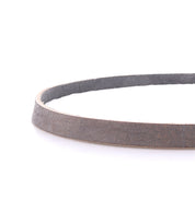 A close-up of the Bed Stu Monae brown leather belt with a suede inner lining, coiled on a white background—perfect for adding boho charm to any outfit.