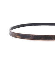 The Bed Stu Monae is a brown leather skinny belt with vintage creases, styled in a circular shape on a white background—a timeless women’s fashion accent.