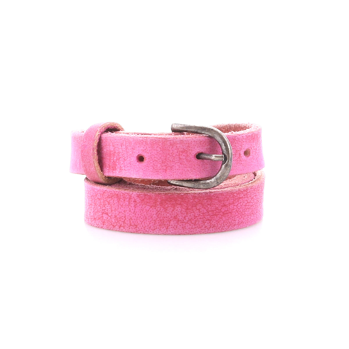 The Bed Stu Monae is a pink skinny leather belt with a distressed texture and silver buckle, coiled on a white background—ideal for adding a boho touch to your outfit.