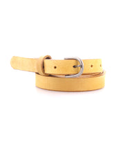 The Bed Stu Monae is a yellow suede skinny belt with a silver buckle, shown coiled in a loop on a white background.