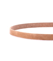 A simple light brown leather Monae belt by Bed Stu is shown coiled against a white background.