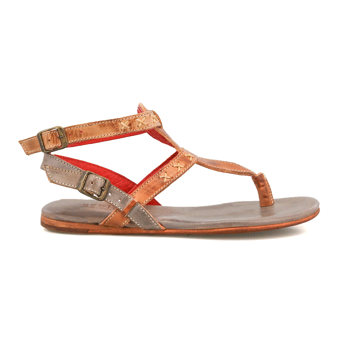 The Bed Stu Moon sandal features brown leather, two adjustable ankle buckles, a flat sole, cushioned insole, and red inner lining, displayed in a side profile view.