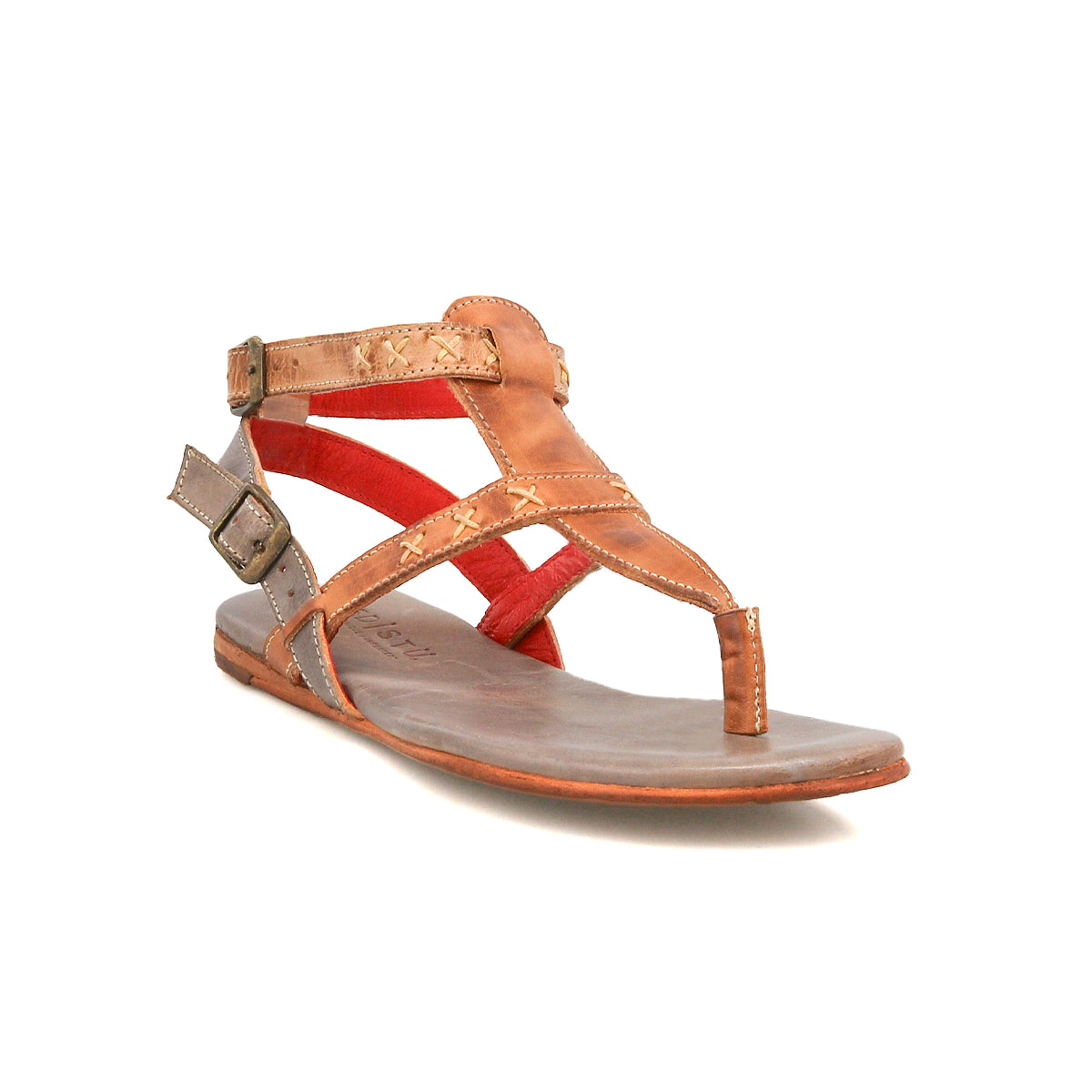 The Bed Stu Moon is a brown leather sandal with two buckled straps and red accents, featuring an open toe, flat sole, and cushioned insole for all-day comfort.