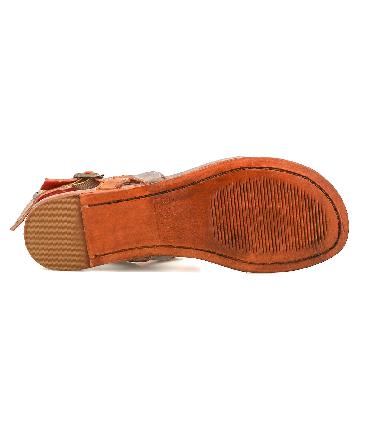 The image shows the bottom view of the Bed Stu Moon sandal, featuring brown leather, a textured rubber sole, smooth heel section, and an ankle buckle.