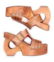 The Bed Stu Mutable sandals feature vintage wooden platforms, tan leather straps with metal studs, and a decorative buckle, shown side by side on a white background.