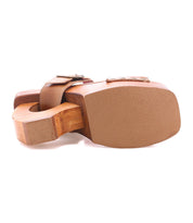 The Bed Stu Mutable is a vintage-inspired wooden clog sandal with a thick curved platform heel and tan leather straps, shown from the bottom view.