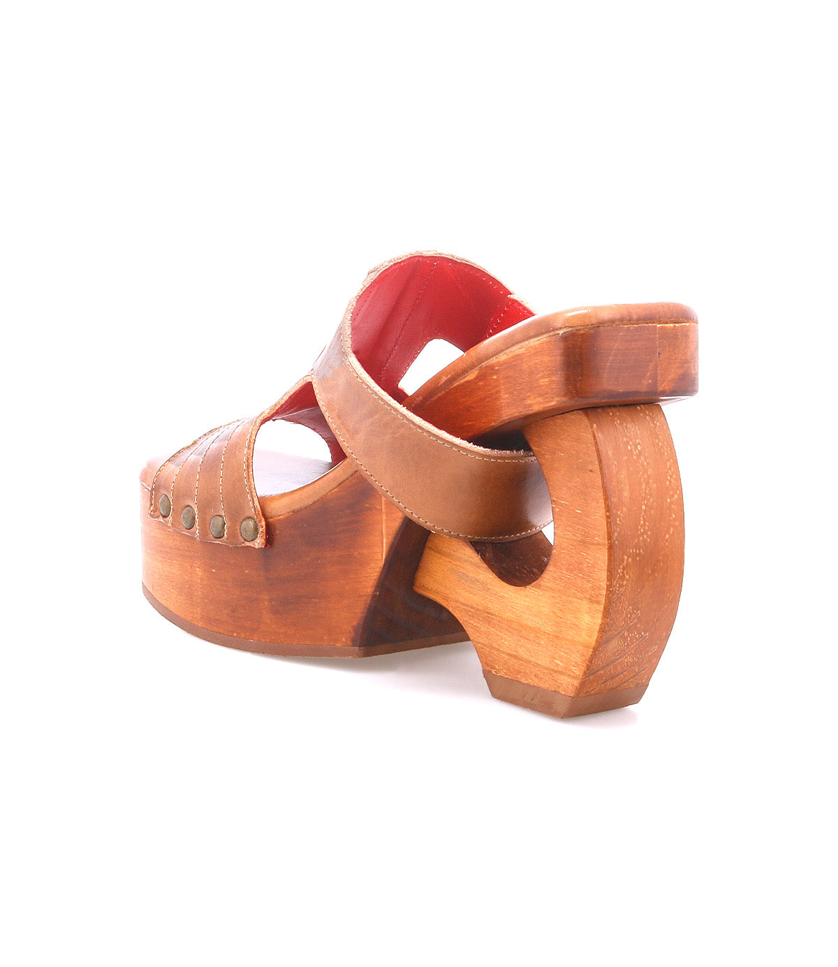 The Bed Stu Mutable sandal is a vintage-inspired wooden platform with a curved heel, open toe, studded brown leather straps, decorative buckle, and red interior lining, displayed on a white background.