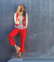A woman in Naiya by Bed Stu leaning against a wall.