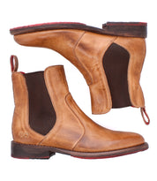 The Bed|Stü Nandi is a brown leather Chelsea boot with dark elastic panels, red soles, pull tabs, shown from side and bottom views.