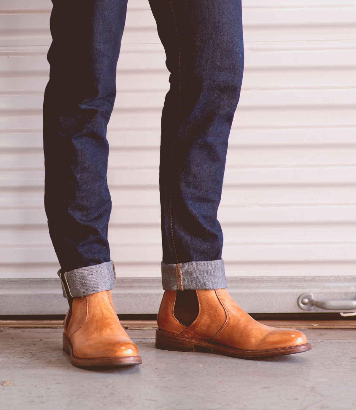 A man wearing timeless Bed Stu Nando tan leather ankle boots.
