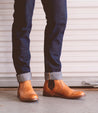 A man wearing timeless Bed Stu Nando tan leather ankle boots.