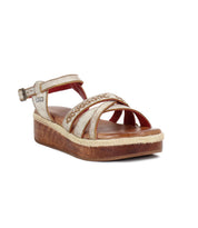 The Necessary sandal by Bed Stu features metallic stitched straps, a braided accent, an adjustable brass buckle, and a thick wooden flatform sole with a wood-like finish and rope trim.