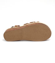 The image shows the flat, tan sole of the Bed Stu Necessary sandal from below, featuring a slightly textured surface, visible edge stitching, and hints of stylish stitched straps above.