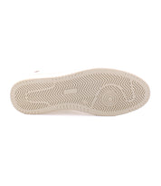 The image shows the bottom view of a beige men's footwear sneaker sole, featuring a herringbone tread pattern with a circular design near the front. The high-quality leather construction of the Bed Stu North adds durability and style.