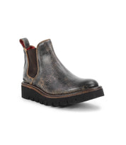 The Bed Stu Novel II is a single dark brown Chelsea boot featuring a distressed leather upper, elastic side panels, pull tab, and a thick black lightweight sole, shown on a white background.