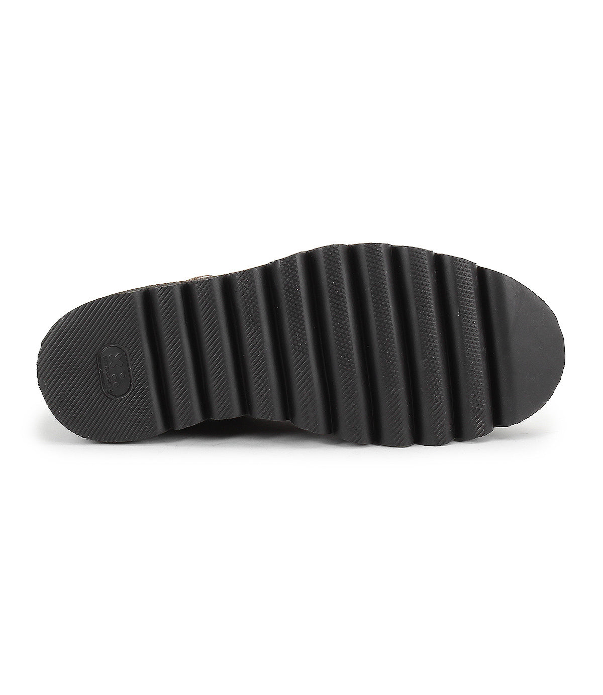 The Bed Stu Novel II features a black shoe sole with deep, horizontal ridges and textured grip, viewed from the bottom against a white background. This Chelsea boot offers a lightweight sole for comfort and style.