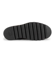 The Bed Stu Novel II features a black shoe sole with deep, horizontal ridges and textured grip, viewed from the bottom against a white background. This Chelsea boot offers a lightweight sole for comfort and style.