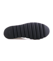 The Bed Stu Novel II features a black sole with horizontal ridges, seen from the bottom against a white background. Designed for Chelsea boots, this lightweight sole blends style and comfort.