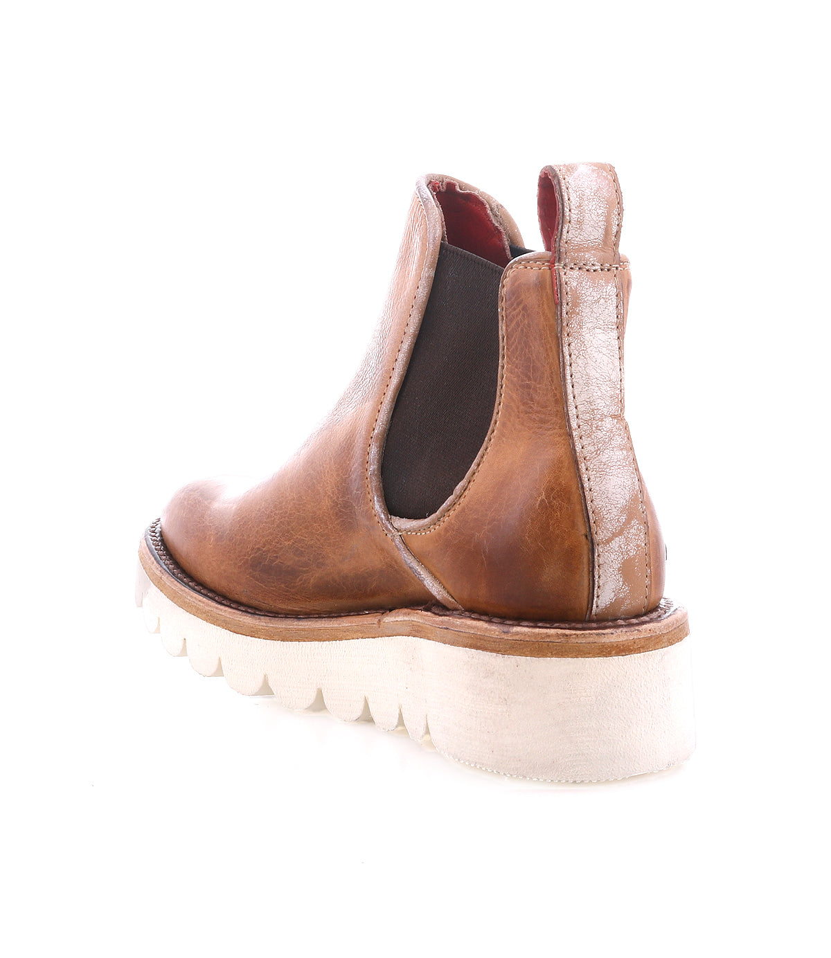 The Bed Stu Novel II is a brown leather Chelsea boot featuring elastic side panels and a thick, lightweight white ridged sole, shown from the back and slightly angled.