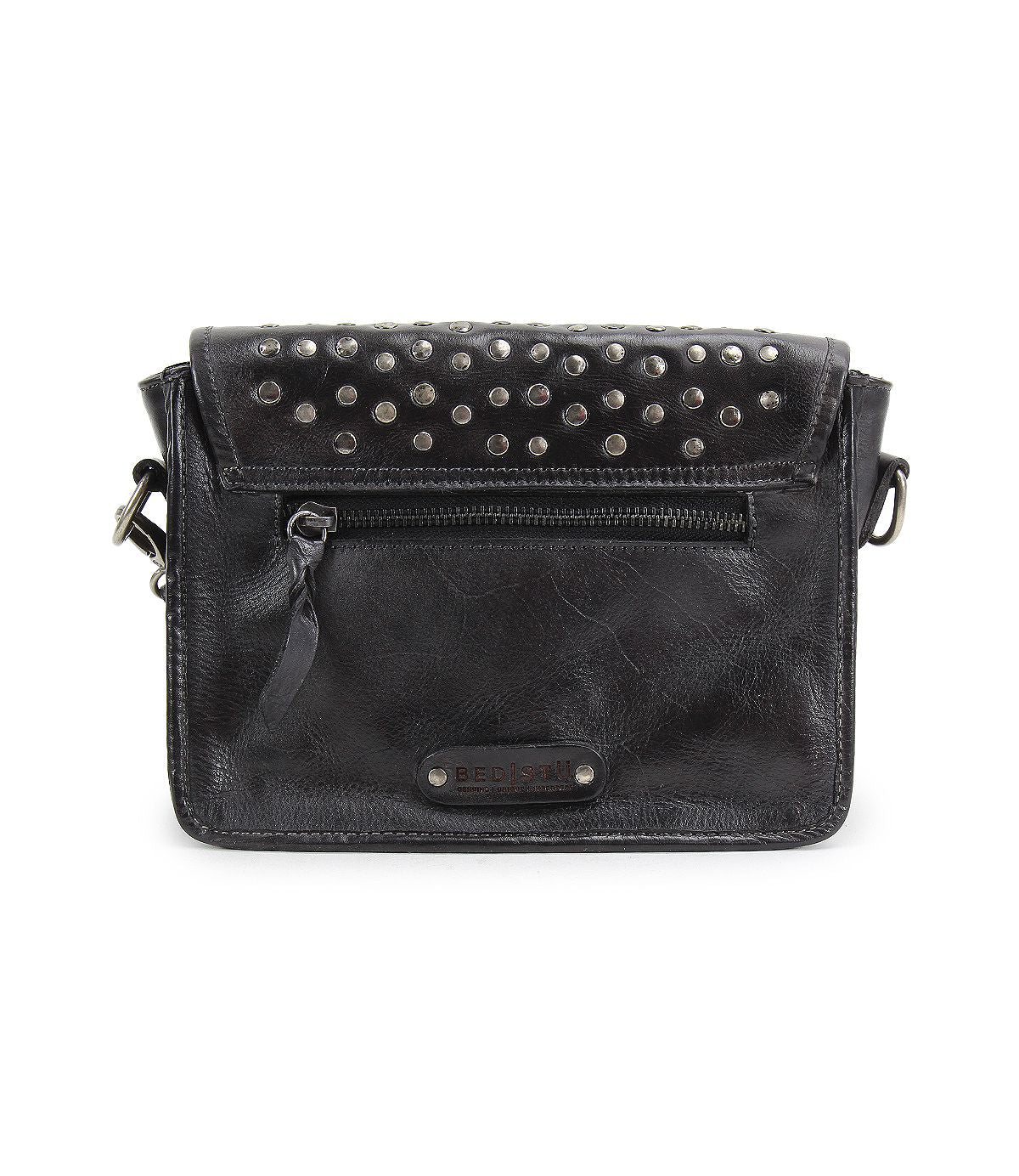 The Occurrence by Bed Stu is a black leather crossbody bag with an edgy design, featuring a front zipper pocket and metallic stud accents on the flap.