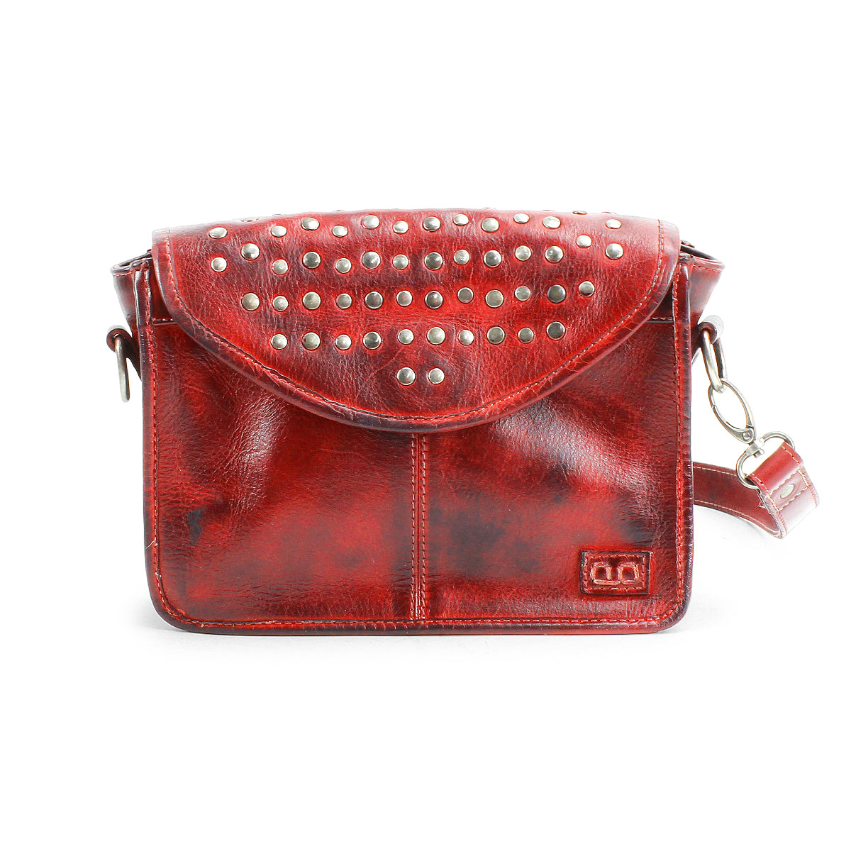 The Bed Stu Occurrence is a red leather crossbody bag with a studded flap, an adjustable strap, and a small rectangular logo in the lower right corner.