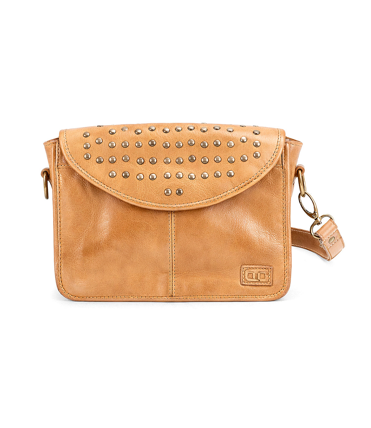 The Bed Stu Occurrence is a tan leather crossbody bag with flap closure, metal stud details, detachable strap, and a small rectangular logo patch on the front—stylish and versatile for any occasion.