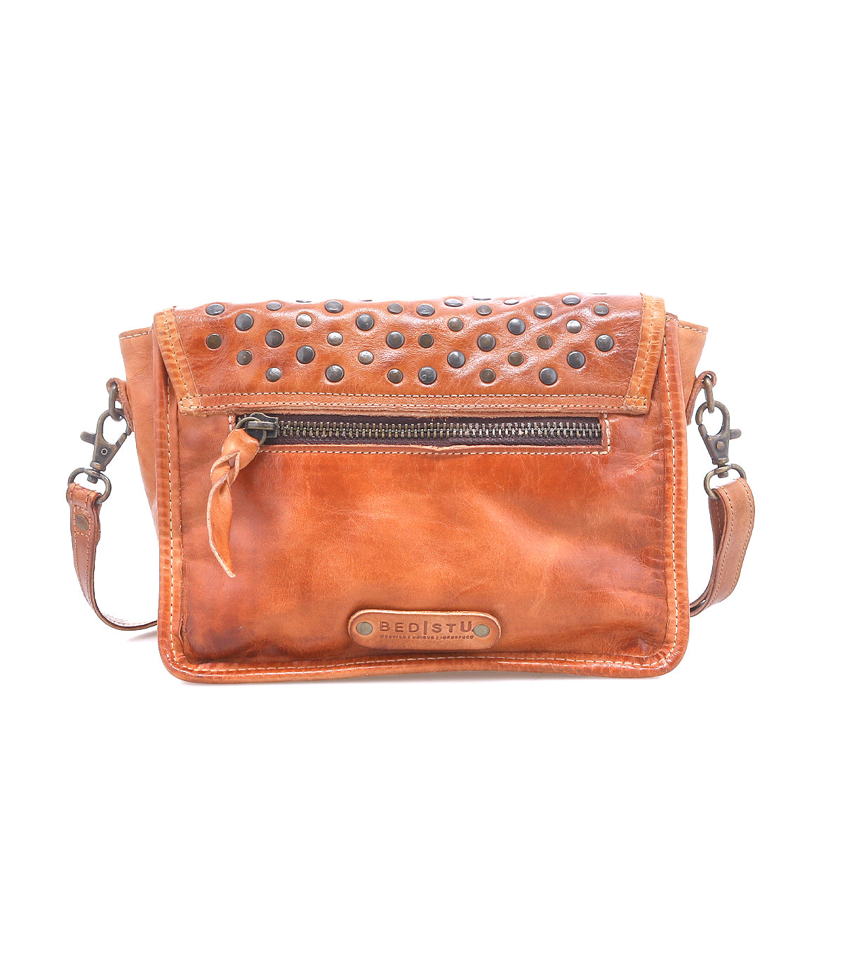 The Bed Stu Occurrence is a brown leather crossbody bag featuring a front zipper pocket, metal-studded flap, and adjustable strap—the ideal grab-and-go accessory.