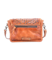 The Bed Stu Occurrence is a brown leather crossbody bag featuring a front zipper pocket, metal-studded flap, and adjustable strap—the ideal grab-and-go accessory.