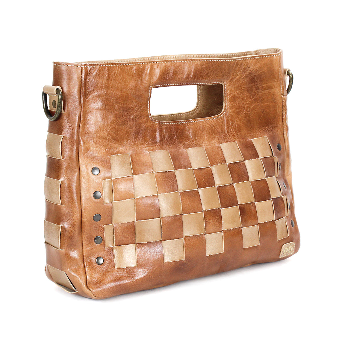 The Orchid by Bed Stu is a brown leather crossbody handbag with a rectangular cutout handle, handwoven lighter leather panels, and metal rivet accents on the sides.
