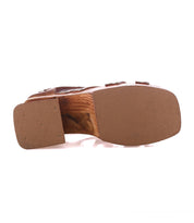 Bottom view of the Bed Stu Orphyx sandal featuring brown layered leather straps, a sculpted wood platform heel, square toe, and textured rubber sole.