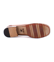 The image shows the sole of a classic brown leather penny loafer with a stacked heel. The text on the sole indicates the shoe size "36" and mentions "Made in Italy," highlighting its fine Italian craftsmanship.
