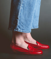 A person wearing red Bed Stu Paris and light blue jeans exudes a classic style that's both timeless and effortlessly chic.