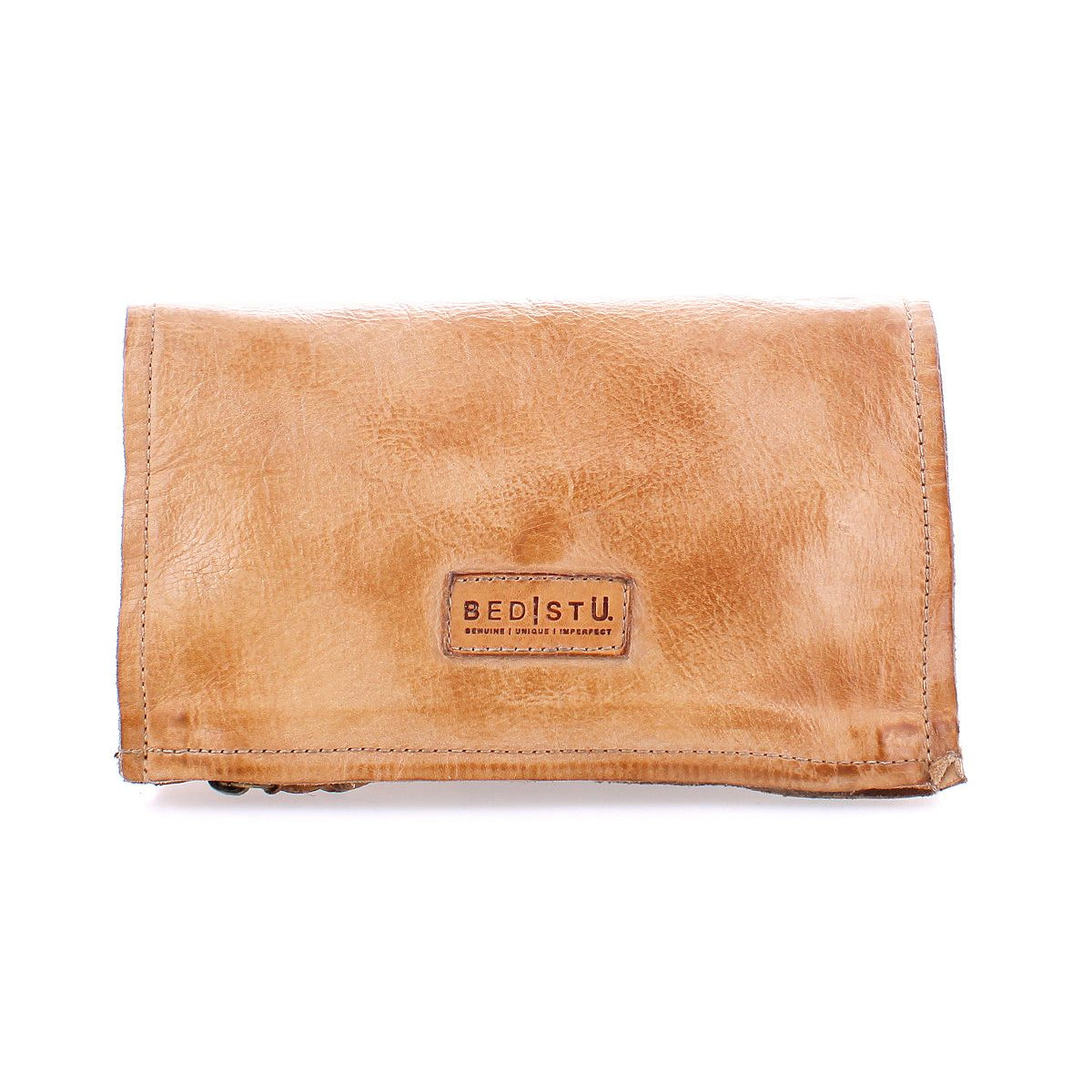The Parle by Bed Stu is a tan leather wallet featuring a stitched "BED|STU" label on the front and zippered compartments for added security.