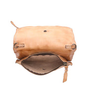 The Bed Stu Parle is a tan leather handbag with an open top flap, unveiling an unzipped main compartment and suede interior, complete with an adjustable crossbody strap for convenience.