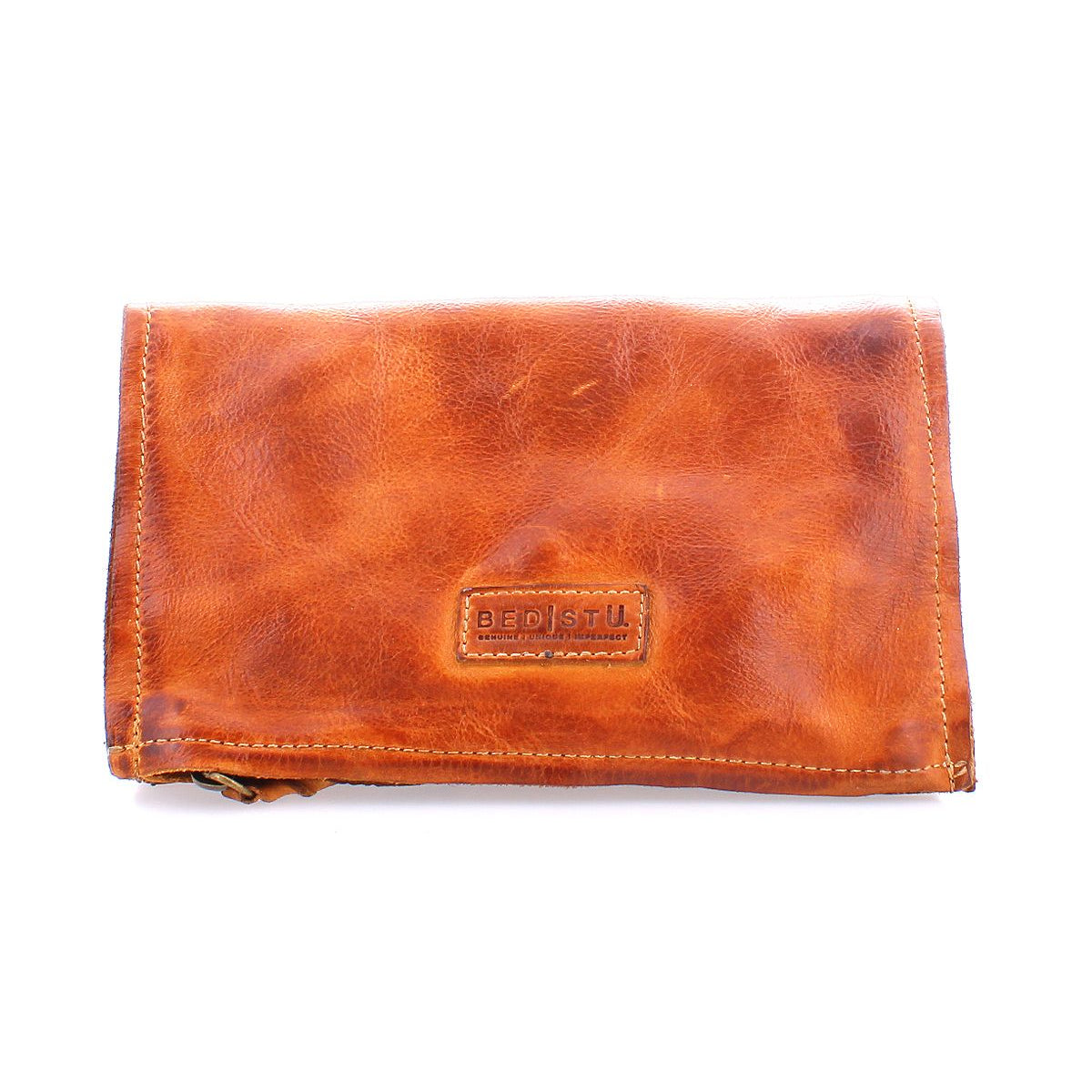The Bed Stu Parle is a brown leather wallet featuring an embossed logo on the front with zippered compartments for security and organization.