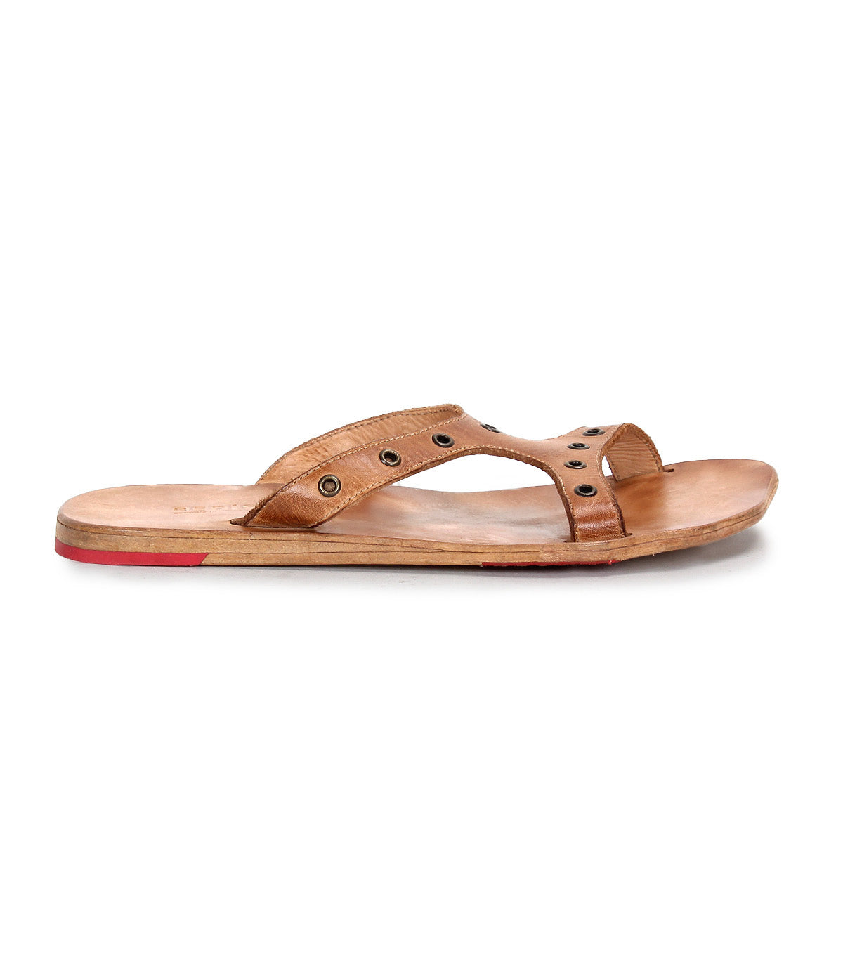 A side view of the Bed Stu Path sandal: a single tan leather shoe with stylish metal grommets, a flat wooden sole, and a red Vibram rubber plate on the heel.