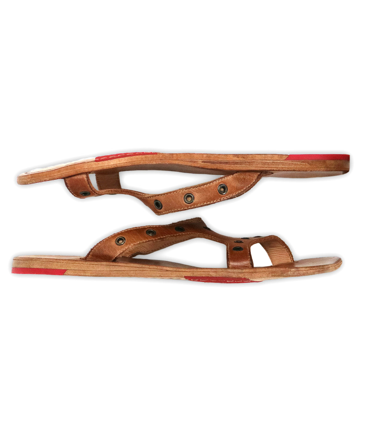 Bed Stu Path sandals: brown leather with stylish metal grommets, flat wooden soles featuring Vibram rubber plates, and red accents on the heel and toe, displayed side by side on a white background.