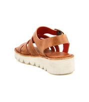 The Bed Stu Perfect sandal features brown leather crisscross straps, an ankle buckle, and a thick white textured platform sole with a cushioned footbed for all-day comfort. Shown from a rear side angle.