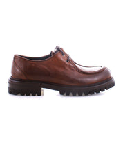 Bed Stu's Portare offers a side view of a vintage-inspired brown leather lace-up shoe, showcasing Italian artistry and complemented by a chunky Livetech outsole.