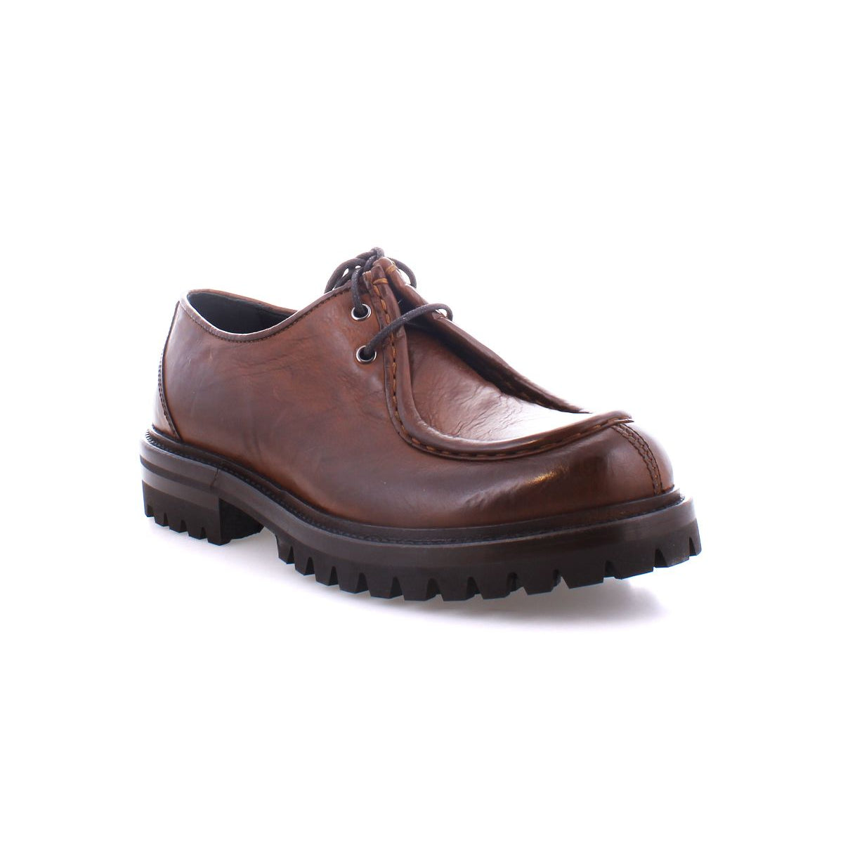 The Portare boot by Bed Stu, a single brown leather moc-toe lace-up design with a rugged sole, displays its vintage-inspired style against a white background.