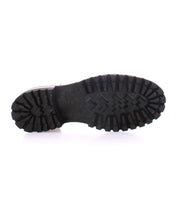 Image of the Portare boot sole by Bed Stu, featuring deep, rugged treads and vintage-inspired design elements against a white background.