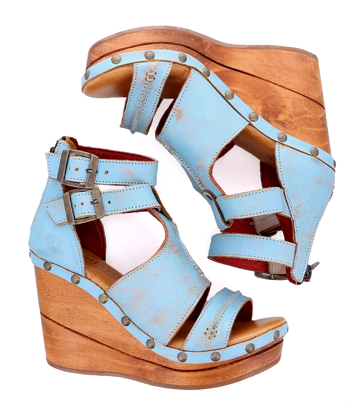 A pair of blue wedge sandals, the Princess sandals by Bed Stu, with sustainable wooden straps and woven strappy uppers.