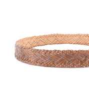 A close-up of the Bed Stu Proem brown handwoven leather belt with a vintage metal buckle, arranged in a circle on a white background.