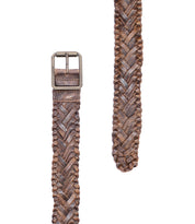 The Proem belt by Bed|Stü, featuring handwoven brown leather with artisan detailing and a vintage metal buckle, is displayed laid out on a white background.